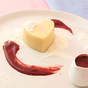 Shape It Vanilla Heart Cakes filled with pureed raspberry and topped with strawberry coulis and a light dusting of meringue dust.