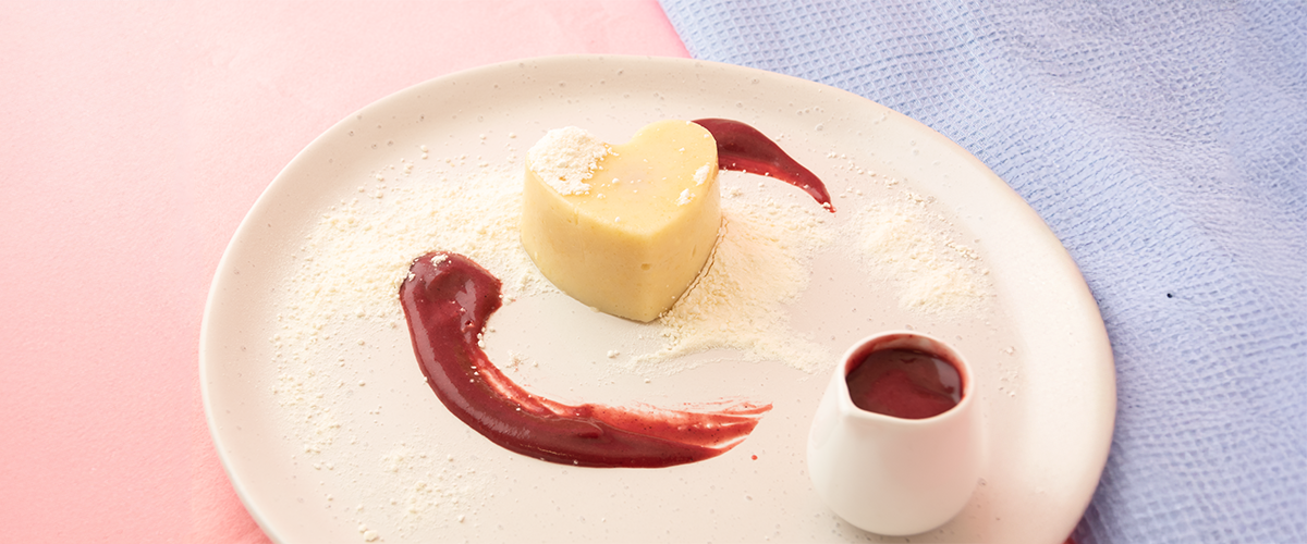 Shape It Vanilla Heart Cakes filled with pureed raspberry and topped with strawberry coulis and a light dusting of meringue dust.